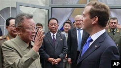 North Korean leader Kim Jong Il (L) says goodbye to Russian President Dmitry Medvedev (R) after a meeting at a military garrison, outside Ulan-Ude in Byryatia, Russia, August 24, 2011