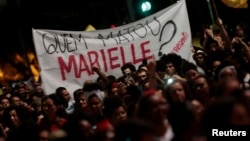 People take part in a rally against the murder of Brazilian councilwoman Marielle Franco, in Sao Paulo, Brazil, March 15, 2018.