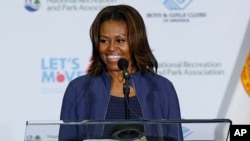 FILE - First lady Michelle Obama speaks at a Miami parks and recreation center to promote her "Let's Move" campaign, Feb. 25, 2014. 