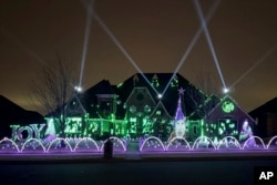 An elaborate holiday light display featuring music and imagery from the movie "Wicked" lights up the home of Elisabeth and Mark Miranda in Edmond, Okla., Dec. 8, 2024. (Elisabeth Miranda via AP)