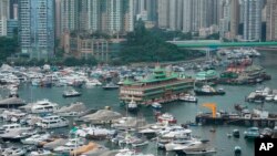 Hong Kong's Jumbo Floating Restaurant is towed away in Hong Kong, Tuesday, June 14, 2022. The parent company failed to find a new owner and lacked funds to maintain the establishment amid months of COVID-19 restrictions. (AP Photo/Kin Cheung)