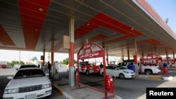 Drivers fill up their vehicles at a gas station in the holy Shi'ite city of Najaf, Iraq, Sept. 16, 2019. 