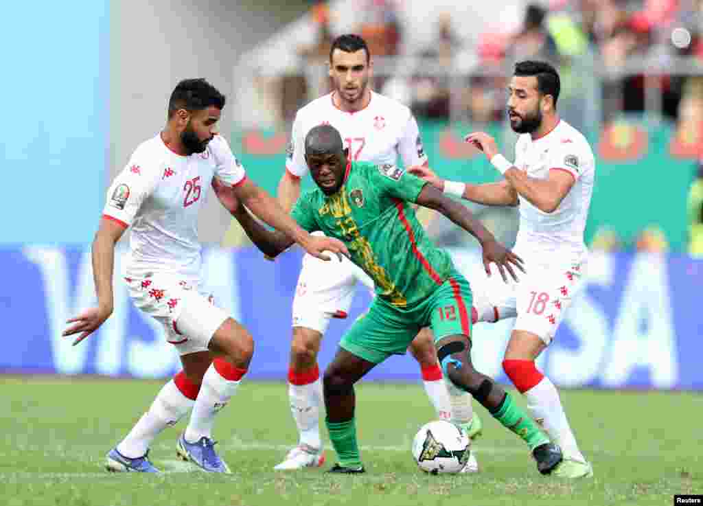 Mauritania's Almike Moussa Ndiaye in action with Tunisia's Anis Ben Slimane; Cameroon, Jan. 16, 2022.