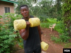 Bodybuilder Samuel Kulbila has gained an international following from posting videos of workouts done with improvised equipment, like concrete weights. Accra, Ghana, July 5, 2020. (Stacey Knott/VOA)