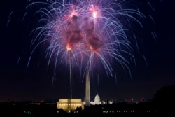 FILE - Fireworks explode over Lincoln Memorial, Washington Monument and U.S. Capitol along the National Mall in Washington, July 4, 2018, during the Fourth of July celebration.