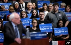 Audience members listen as Democratic presidential candidate, Sen. Bernie Sanders, I-Vt., speaks at a campaign rally, in Dearborn, Mich., March 7, 2016.