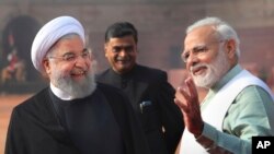 Indian Prime Minister Narendra Modi, right, talks to Iranian President Hassan Rouhani, left, during a ceremonial reception at the Indian presidential palace in New Delhi, India, Feb. 17, 2018.