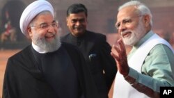 Indian Prime Minister Narendra Modi, right, talks to Iranian President Hassan Rouhani, left, during a ceremonial reception at the Indian presidential palace in New Delhi, India, Feb. 17, 2018.