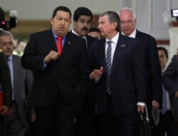 Venezuela’s president Hugo Chavez, left, speaks with Igor Sechin, CEO of Russia's state-controlled Rosneft oil company, at Miraflores presidential palace in Caracas, Venezuela, Thursday, Sept. 27, 2012.