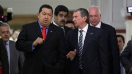 Venezuela’s president Hugo Chavez, left, speaks with Igor Sechin, CEO of Russia's state-controlled Rosneft oil company, at Miraflores presidential palace in Caracas, Venezuela, Thursday, Sept. 27, 2012.