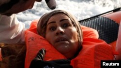 A migrant reacts after being rescued by the Malta-based NGO Migrant Offshore Aid Station (MOAS) after they were spotted adrift on board a wooden boat in the central Mediterranean north of Sabratha on the Libyan coast, April 5, 2017.