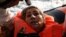A migrant reacts after being rescued by the Malta-based NGO Migrant Offshore Aid Station (MOAS) after they were spotted adrift on board a wooden boat in the central Mediterranean north of Sabratha on the Libyan coast, April 5, 2017.
