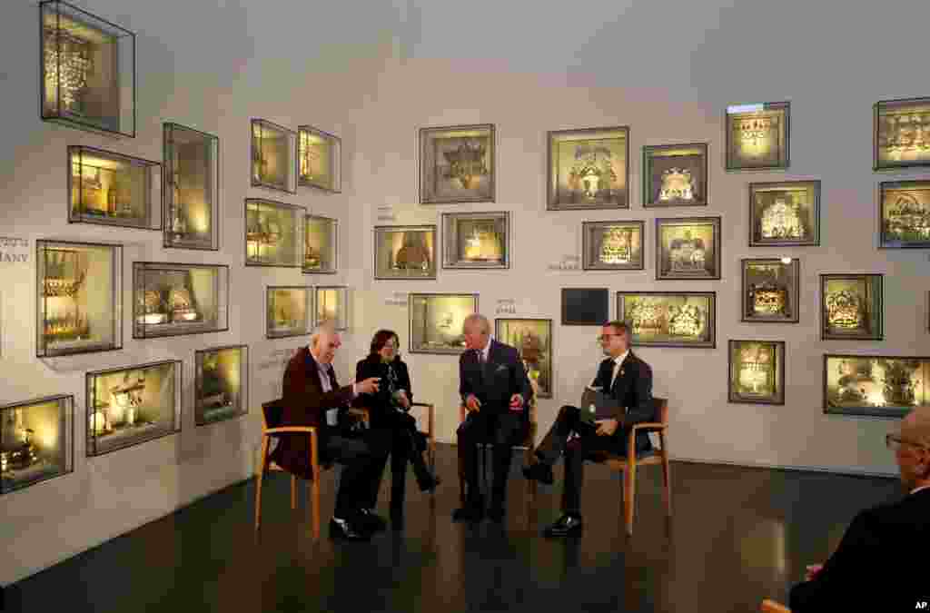 Britain&#39;s Prince Charles, second right, speaks with Holocaust survivor Marta Wise, second left, and George Shefi, left, whose mother perished at Auschwitz, during a reception at the Israel Museum in Jerusalem.