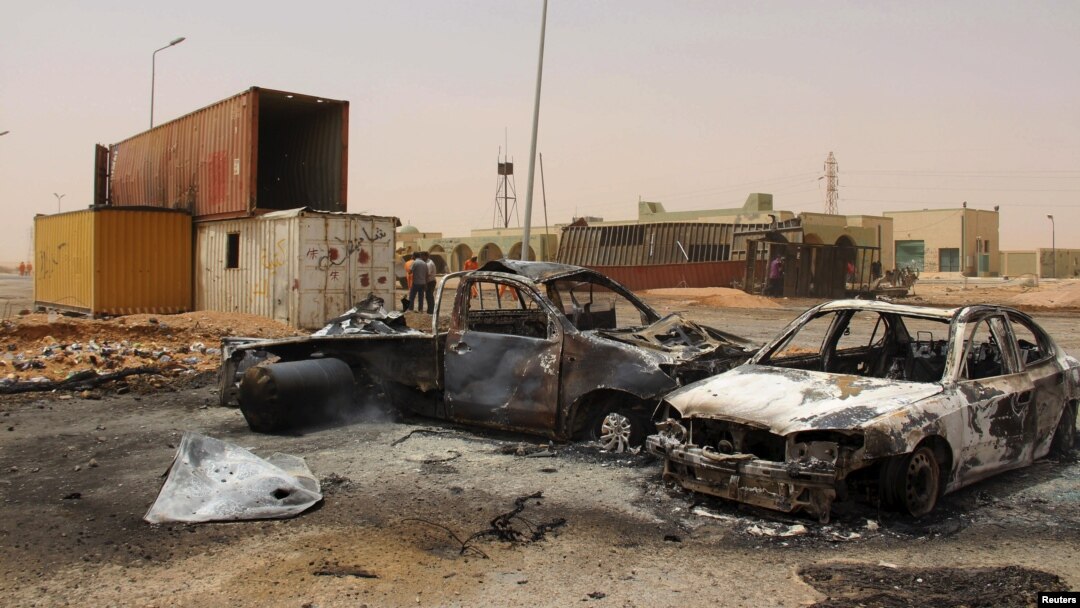 FILE - Vehicle wreckages are seen after a suicide car bomber blew himself at a checkpoint near Misrata, Libya, May 21, 2015.