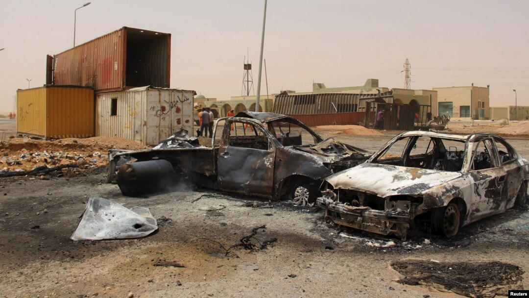 FILE - The wreckage of vehicles is seen after a suicide car bomber blew himself at a checkpoint near Misrata, Libya, May 21, 2015.