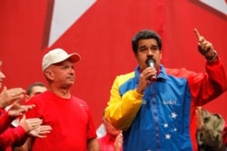 FILE - Venezuela's President Nicolas Maduro, right, speaks next to retired General Hugo Carvajal as they attend the Socialist party congress in Caracas, July 27, 2014.