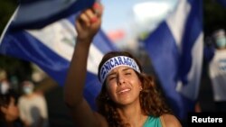 A demonstrator cries as she sings a song during a protest in Managua, Nicaragua, June 18, 2018. 