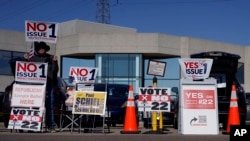 People gather in the parking lot of the Hamilton County Board of Elections as people arrive for early in-person voting in Cincinnati, Nov. 2, 2023.