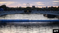 This photograph taken on Aug. 20, 2023, shows the starting line dedicated to the swim familiarisation event of the 2023 World Triathlon Olympic Games Test Event floating underneath the Alexandre III bridge on the Seine river ahead of the mixed relay 202