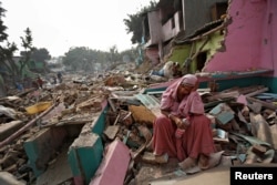 A woman reacts amid the rubble of her home in a slum which was razed to the ground by local authorities in a bid to relocate the residents, Delhi, India, November 2, 2017.