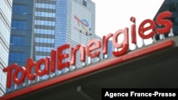FILE - This May 28, 2021, photo shows the new TotalEnergies logo during its unveiling ceremony, at a charging station in La Defense on the outskirts of Paris.
