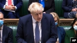 In this grab taken from video, Britain's Prime Minister Boris Johnson makes a statement ahead of Prime Minister's Questions in the House of Commons, London, Jan. 12, 2022.