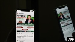 Seorang pria melihat situs resmi partai Pakistan Tehreek-e-Insaf (PTI) ketika partai itu meluncurkan kampanye pemilu dan penggalangan dana secara virtual di Islamabad, 7 Januari 2024. (Foto: Aamir QURESHI / AFP)