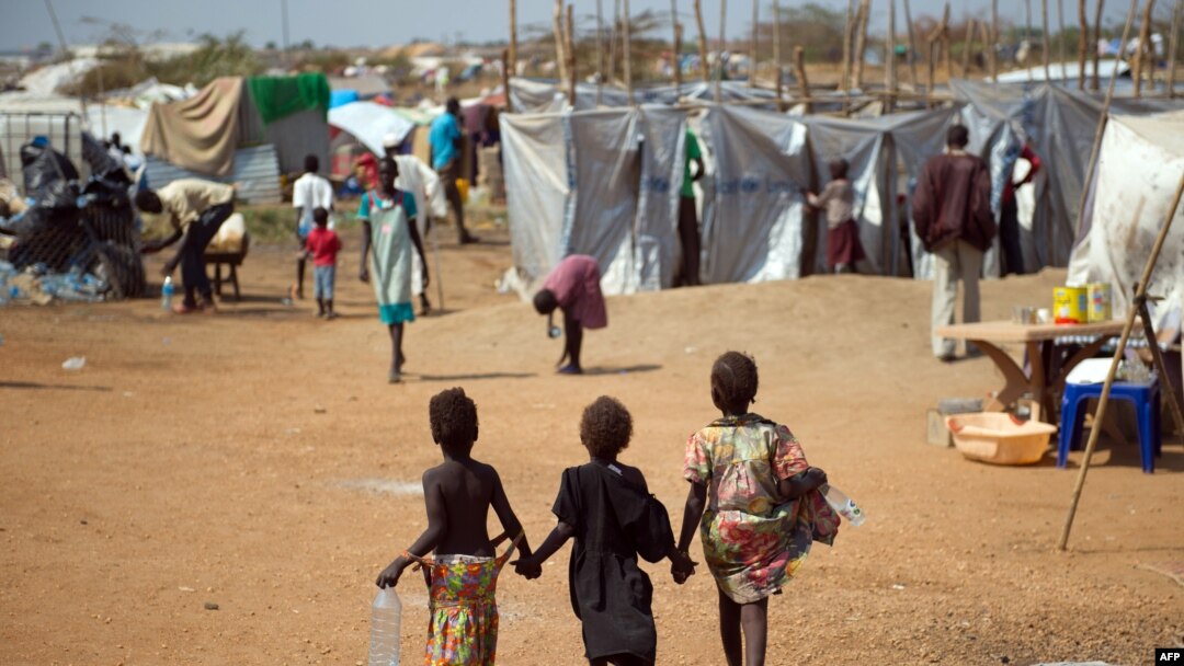 Three children walk through a camp for internally displaced persons at the United Nations Mission to South Sudan (UNMISS) base in Juba, Jan. 9, 2014.