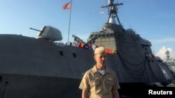 FILE - Chief of U.S. Naval Operations Admiral John Richardson poses after speaking to reporters on the pier of the USS Coronado, a littoral combat ship, at the Changi Naval Base in Singapore, May 16, 2017. 