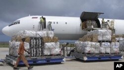 Tons of relief from the United Nations High Commissioner for Refugees (UNHCR) are offloaded after landing at Mogadishu airport, Somalia, Monday, Aug. 8, 2011
