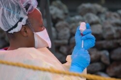 FILE - A nurse prepares a vaccine against Ebola in Goma, Democratic Republic of Congo, Aug. 7, 2019.