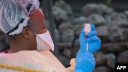 FILE - A nurse prepares a vaccine against Ebola in Goma, DRC, Aug. 7, 2019. 