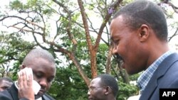 FILE - Erias Lukwago (L) walks with Forum for Democratic Change (FDC) representative Maj. Gen. Mugisha Muntu (R).