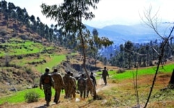 FILE - Pakistani soldiers patrol in the area where Indian planes launched a pre-dawn airstrike inside Pakistan, in Jaba, near Balakot, Pakistan, Feb. 27, 2019.