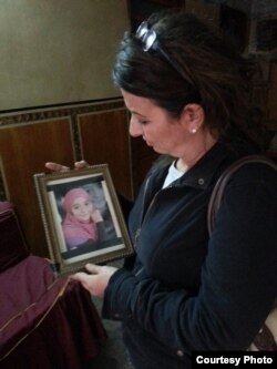 Saud Abu-Dayyeh visits the family home and holds a picture of Soheir al-Batea, who died at 13 due to complications associated with FGM, Aga, Egypt, November, 2013. (Equality Now)