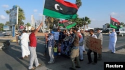 FILE - Protesters demonstrate against the U.N. draft agreement for a political settlement between the parallel governments in Libya, in Benghazi, Sept. 18, 2015.