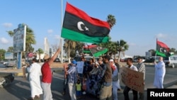 FILE - Protesters demonstrate against U.N. draft agreement for political settlement between parallel governments, Benghazi, Libya, Sept. 18, 2015.