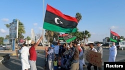 FILE - Protesters demonstrate against the U.N. draft agreement for a political settlement between the parallel governments in Libya, in Benghazi, Sept. 18, 2015.