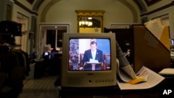 Sen. Ted Cruz, R-Texas, is seen on a television screen in the Senate Press Gallery during the tenth hour of his speech on the Senate floor in Washington, Sept. 25, 2013.