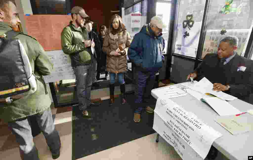 Voters check in at a polling station for Massachusetts&#39; primary election in the East Boston neighborhood in Boston, Massachusetts, March 1, 2016.