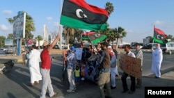 FILE - Protesters demonstrate against the U.N. draft agreement for a political settlement between the parallel governments in Libya, in Benghazi, Sept. 18, 2015. 