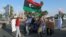 FILE - Protesters demonstrate against the U.N. draft agreement for a political settlement between the parallel governments in Libya, in Benghazi, Sept. 18, 2015. 