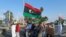 FILE - Protesters demonstrate against the U.N. draft agreement for a political settlement between the parallel governments in Libya, in Benghazi, Sept. 18, 2015.