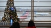 Passengers wait for their flights at Ronald Reagan Washington National Airport in Arlington, Virginia, on November 22, 2024, ahead of the upcoming Thanksgiving holiday. (Photo by ROBERTO SCHMIDT / AFP)