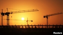 Cranes operate at the site of the football stadium in Benghazi, Libya, Jan. 19, 2013.