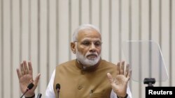 FILE - India's Prime Minister Narendra Modi gestures as he addresses the gathering during the 'Global Mobility Summit' in New Delhi, India, Sept. 7, 2018.