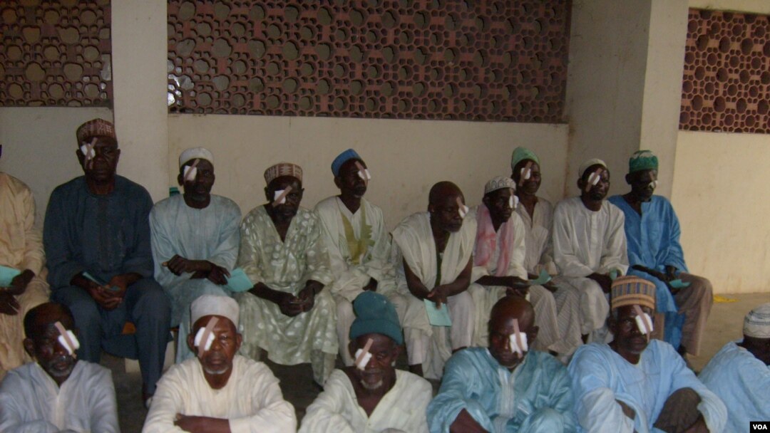 A group of men in Kano, Nigeria, wait to have patches removed from their eyes following cataract surgery. (Isiyaku Ahmed/VOA News)