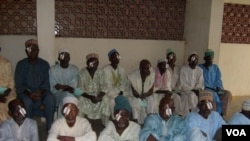 A group of men in Kano, Nigeria, wait to have patches removed from their eyes following cataract surgery. (Isiyaku Ahmed/VOA News)