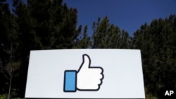 FILE - The Facebook logo is seen at the company's headquarters in Menlo Park, Calif., March 28, 2018. 