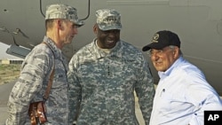 US Defense Secretary Leon Panetta, right, chats with US Generals Anthony Rock, left, and Lloyd Austin during a stop in southern Afghanistan late Sunday, July 10, 2011